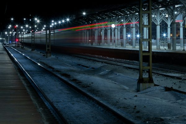 a train traveling down train tracks at night